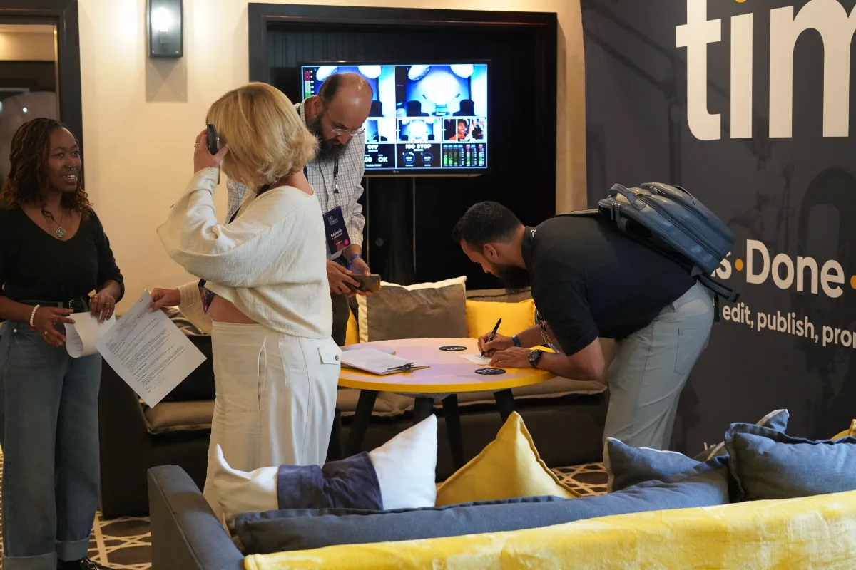 Attendees signing release forms at the Tim Africa lounge