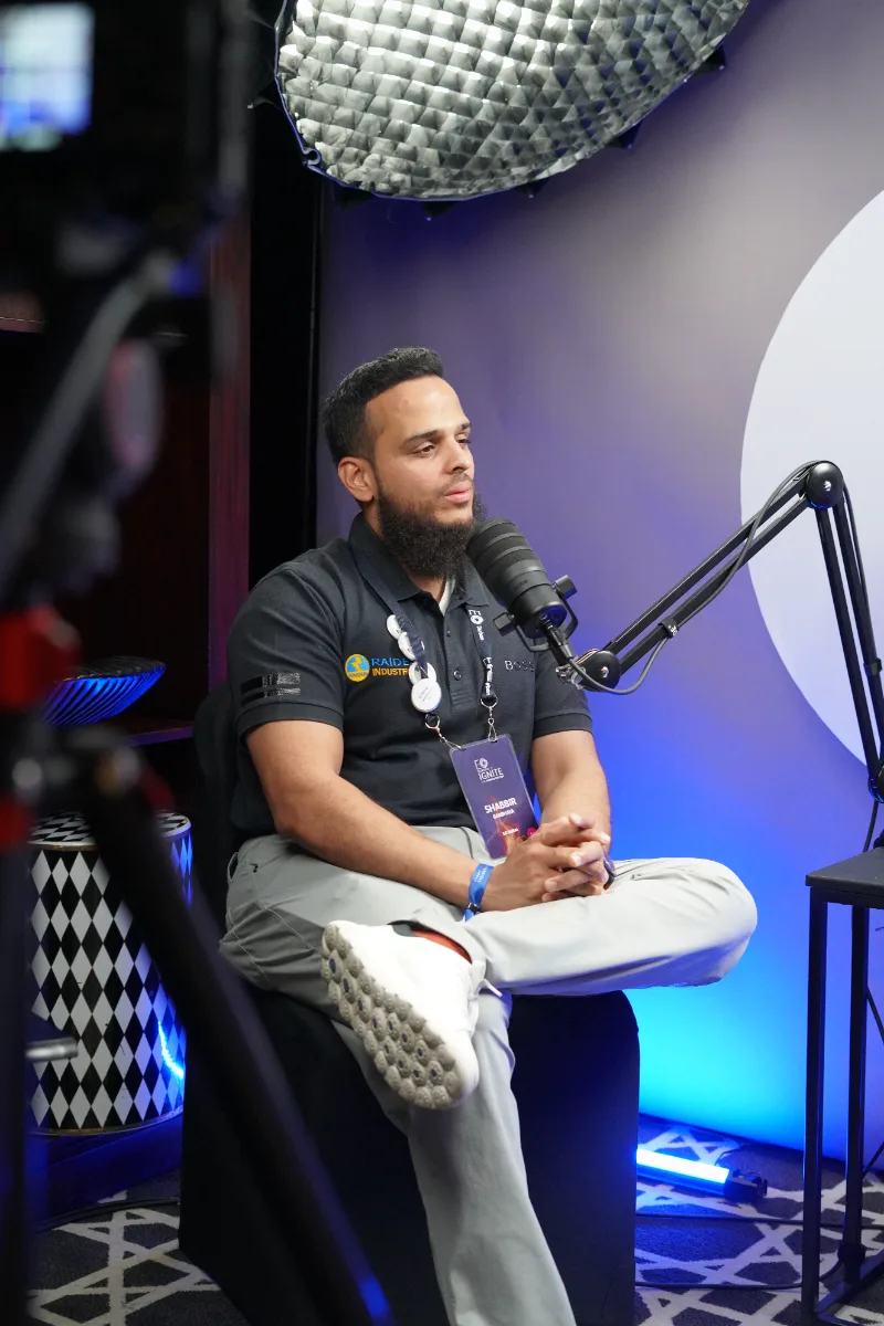 Guest speaking into the studio microphone at EO Ignite