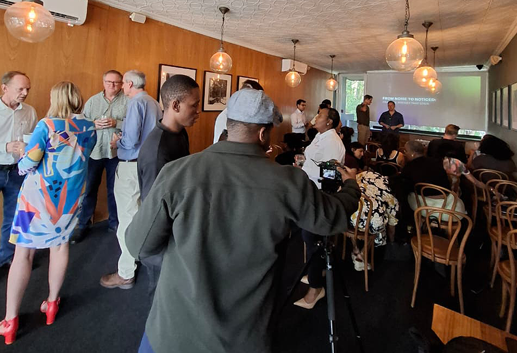 Attendees networking at business pitching event focused on pitch perfect strategies and pitch presentation skills.