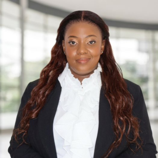 Professional headshot of a woman in a black blazer and white blouse, used for a Heavy Chef Recipe article on YouTube monetisation and content creation.