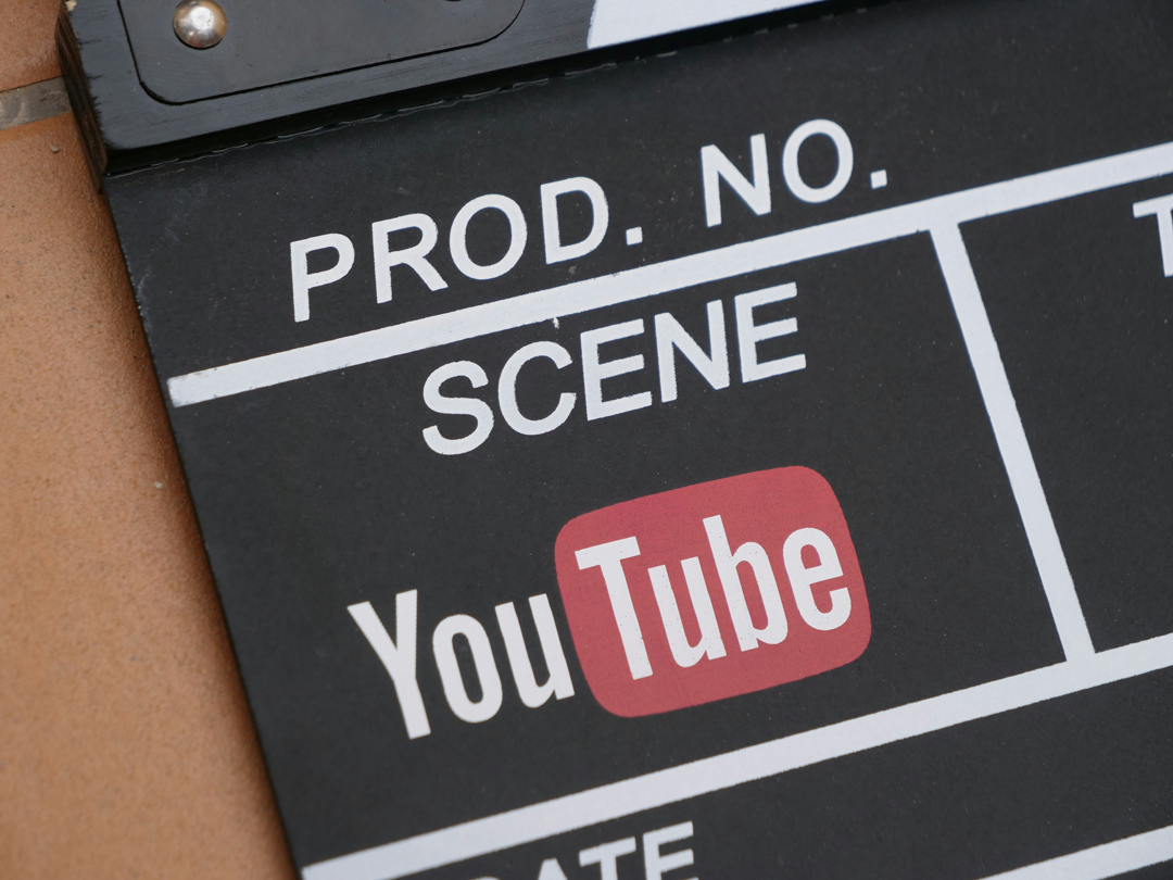 YouTube Monetization concept featuring YouTube logo on film production clapperboard, digital creator economy and video revenue strategy image for Tim Africa website. Photo credit from Polimake on Unsplash