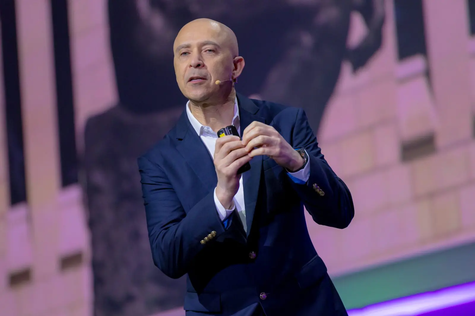A speaker presenting on stage at the summit